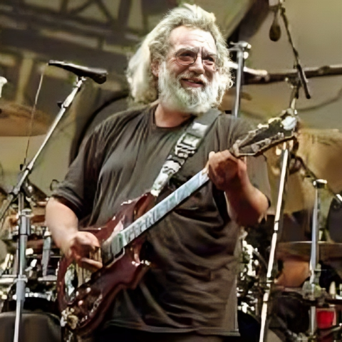 Jerry Garcia playing guitar in the stage.